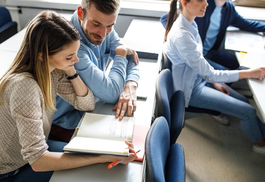 Two professionals comparing training documents
